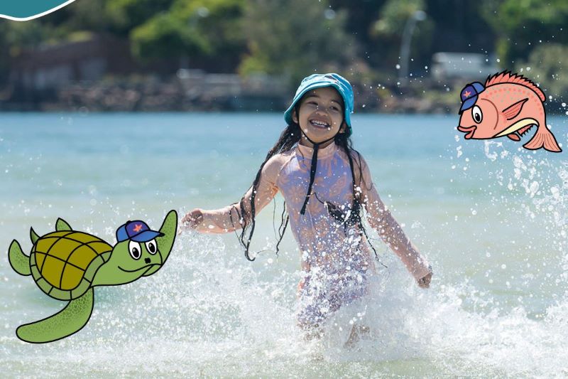 A young girl skips through the water. A cartoon turtle and fish fly beside her